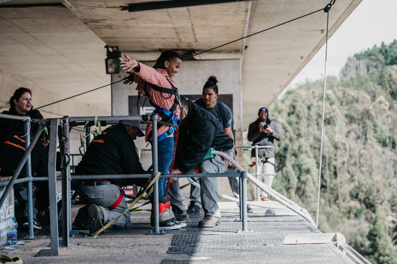 Face Adrenalin crew working at the edge of the jump platform beneath the Bloukrans Bridge deck