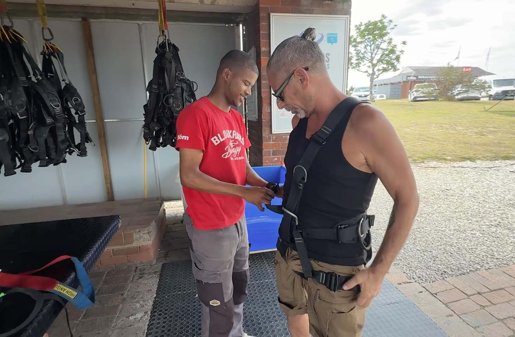 Main getting harnessed by crew at Face Adrenalin
