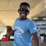 Face Adrenalin crew member in a Bloukrans Bungy shirt beneath the bridge deck