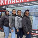 Face Adrenalin crew in front of the SkyWalk tour information board at Bloukrans Bridge