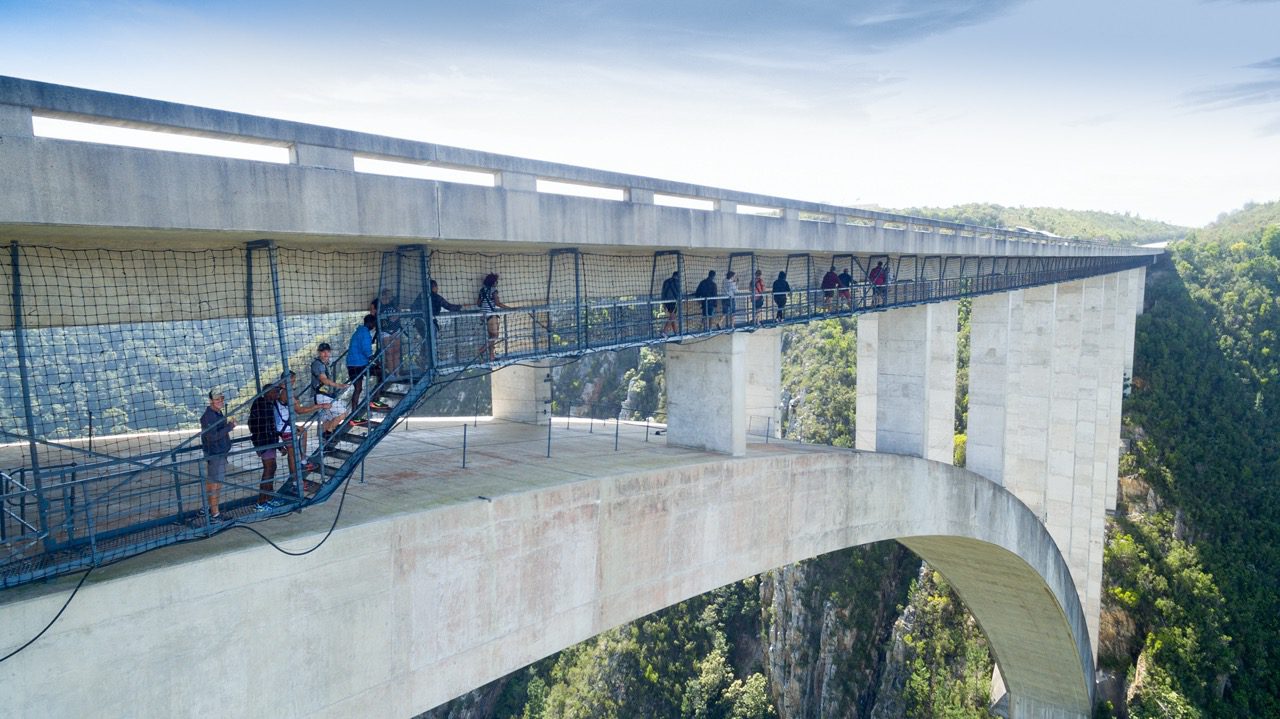 Visitors on the SkyWalk platform beneath the deck of Bloukrans Bridge